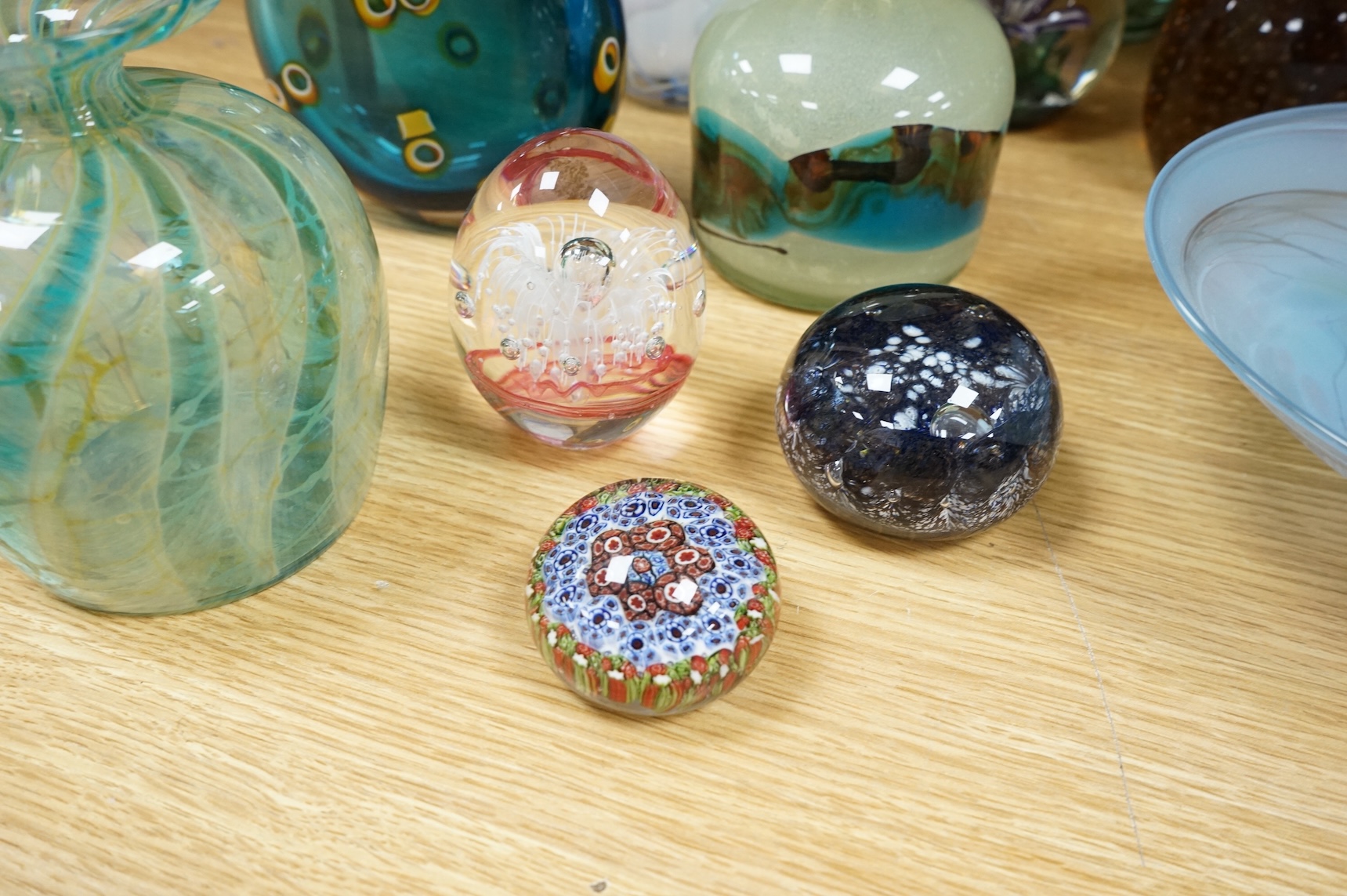 A collection of mixed art glass and paperweights, including two Mdina flared rimmed glass vases, Adrian Shankey glass, an Isle of Wight squat vase, various paperweights and a dump etc. (15)